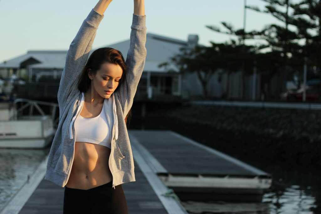 confident woman is strechting on her poolside