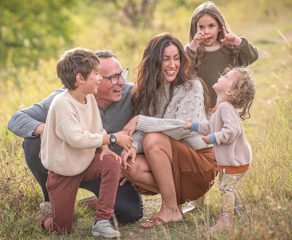 family outside doing a photoshoot with their outfits, having fun and showing their love