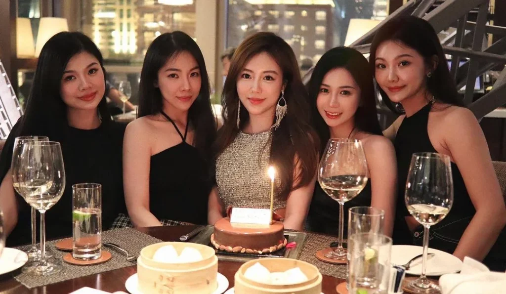 16th birthday photoshoot in a professional setting with a birthday cake and friends