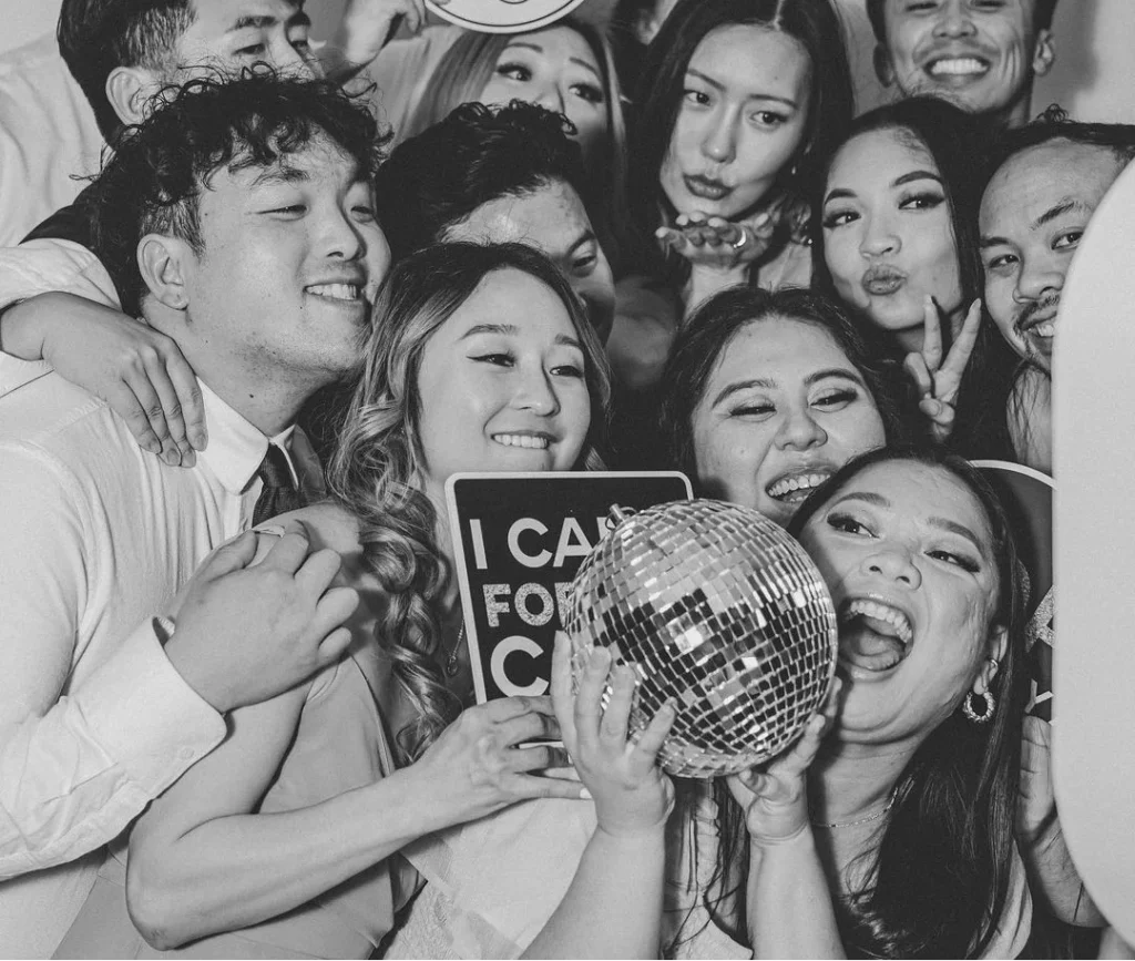 birthday squad having fun posing in a photo booth