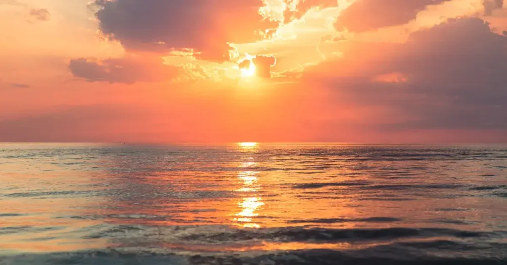 beach photography of the golden hour when the sun sets behind the sea