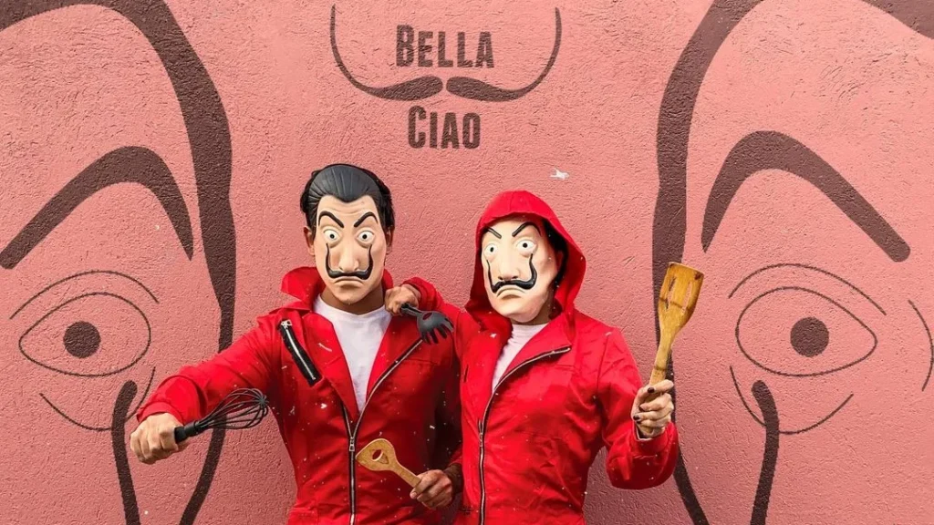 couple in a bella ciao or house of cards costume are posing for a couple halloween photography shooting