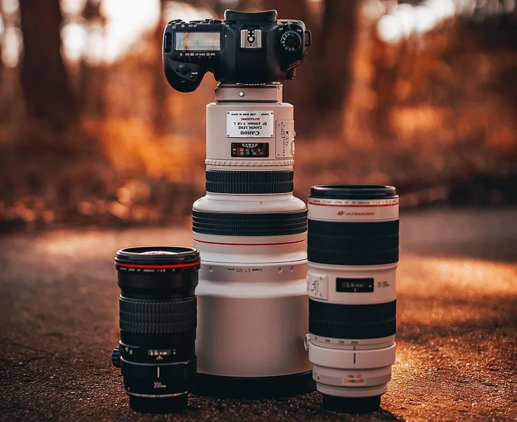 camera with three lenses standing on the ground, showing the best settings for wedding photography
