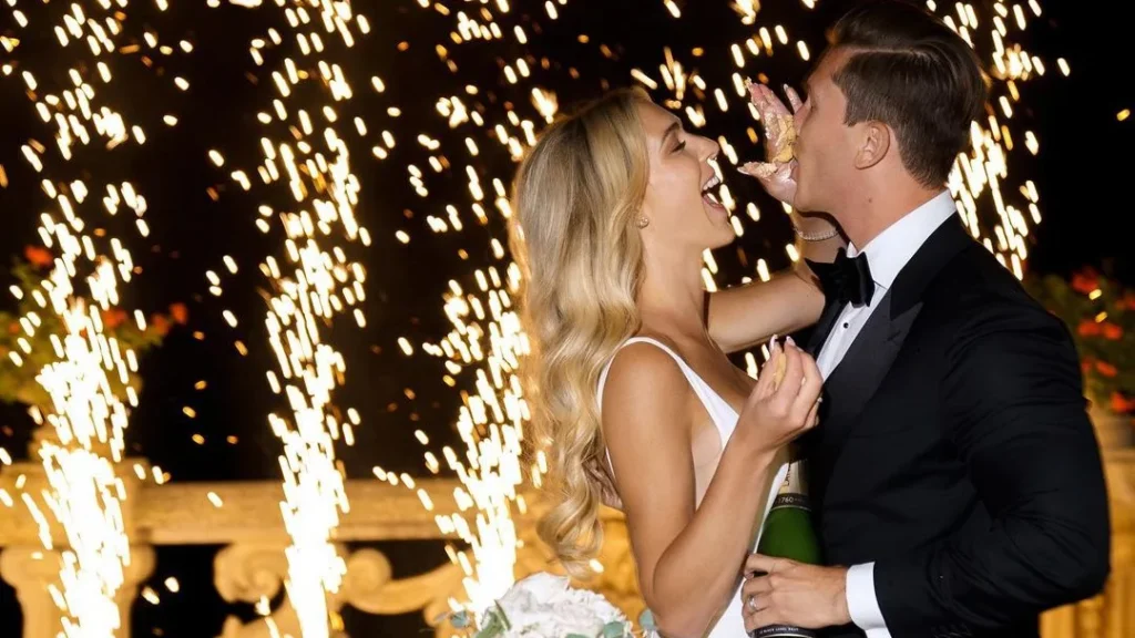 couple having a fun wedding with a wedding photographer with good iso settings to capture the sparkles in the background