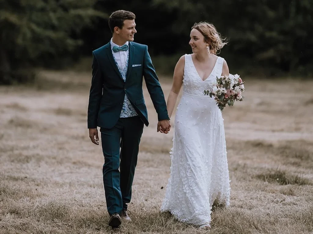 married couple walking off holding hands and looking at each other, high aperture, romantic image of a moody wedding