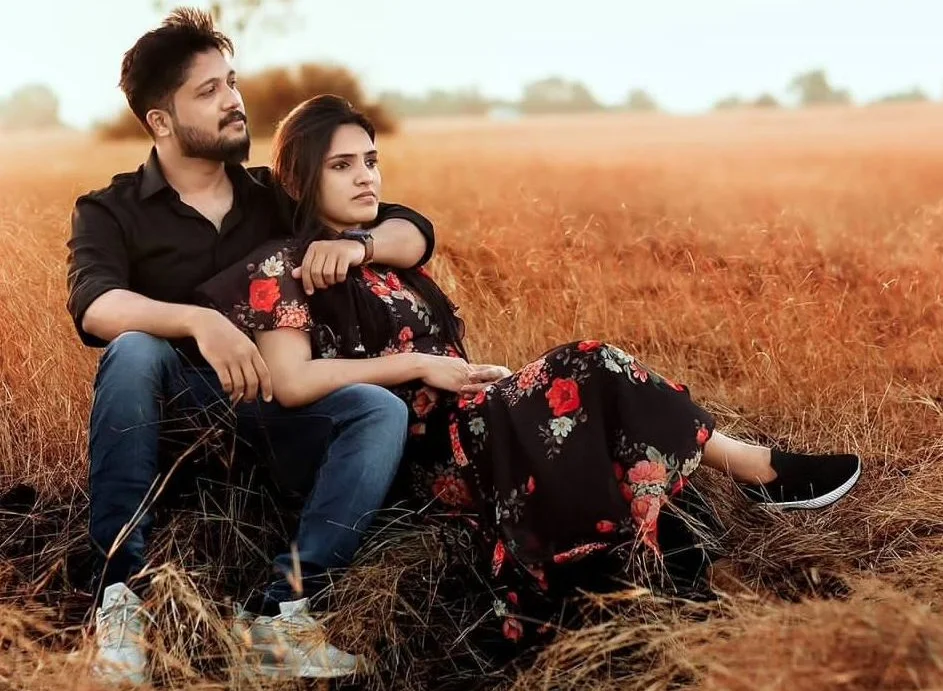 cute couple lying in yellow corn field, romantic atmosphere, nice casual couple outfit, looking into the distance