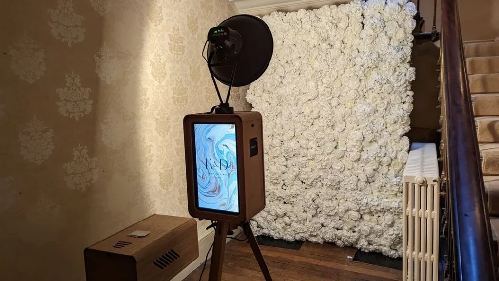 photobooth at a wedding with white roses in the background, professional photo booth for funny birthdays and weddings
